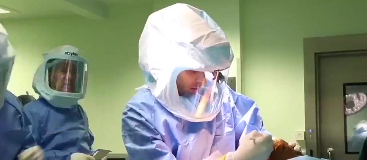 Dr. Muthana Sartawi operating in a sterile surgical helmet